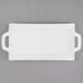A white rectangular porcelain platter with handles.