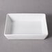 A white rectangular dish on a gray background.