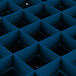 A blue plastic container with a blue square grid and black squares.