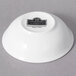 A white porcelain sauce dish with black text that reads "Whittier"