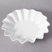 A white 10 Strawberry Street Whittier porcelain bowl with a wavy edge.