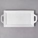 A white rectangular porcelain platter with handles.