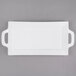 A white rectangular porcelain platter with handles.