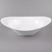 A 10 Strawberry Street Whittier white porcelain swoop bowl on a gray surface.