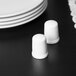A table set with 10 Strawberry Street white porcelain salt and pepper shakers.