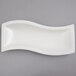 A 10 Strawberry Street Whittier white rectangular porcelain arc platter on a gray background.