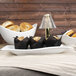 A table with a rectangular white porcelain platter of food on it.