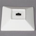 A white square porcelain tid bit tray with a black logo.