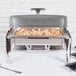 A Vollrath stainless steel chafer filled with shrimp and vegetables on a table.