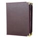 A brown leather Menu Solutions Royal Select booklet cover with gold trim.