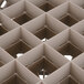 A close-up of a Vollrath beige plastic glass rack with square compartments.
