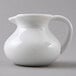 A white plastic creamer with a handle.