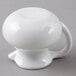 A close-up of a white plastic creamer with a handle.