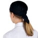 A woman wearing a black Headsweats chef cap.