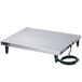 A rectangular stainless steel metal surface with a power cord.
