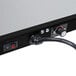 A close-up of a black and silver Hatco portable heated shelf warmer on a table.