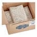 A cardboard box full of dried Great Northern beans.