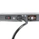 The plug for a Hatco Glo-Ray Portable Heated Shelf Warmer being plugged into a power strip.