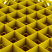 A Vollrath yellow plastic basket with square compartments.