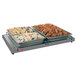 A Hatco Glo-Ray portable heated shelf with trays of food on it.