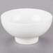 An American Metalcraft porcelain footed bowl on a gray surface.