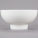 An American Metalcraft white porcelain footed bowl on a gray background.