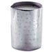 A close-up of an American Metalcraft stainless steel creamer with a hammered metal texture filled with liquid.