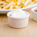 A white Tuxton fluted ramekin filled with white cream.