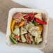 A bowl of pasta with vegetables and peppers in an Eco-gecko palm leaf bowl.