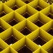 A yellow Vollrath Traex glass rack with square compartments.