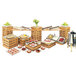 A bamboo rectangular riser shelf on a table full of food at an outdoor buffet.