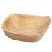 A close up of an Eco-gecko palm leaf bowl with a curved edge.