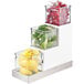 A Cal-Mil three tier glass jar display with lemons in it.