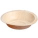 A  Eco-gecko palm leaf bowl with a wood surface.