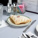 A Tuxton China plate with a pastry on it