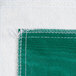 A close-up of a green vinyl table cover with flannel back.