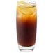 An Arcoroc glass of iced tea with a lemon slice.