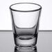 An Arcoroc shot glass with clear glass on a table.