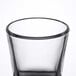 An Arcoroc shot glass with a black rim.