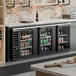 A 95-inch black counter height back bar refrigerator with three glass doors for beverage storage.