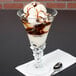 A scoop of chocolate ice cream in an Arc Cardinal Palmier dessert dish.