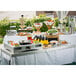 A Tablecraft stainless steel cover on a table with food and drinks on it.