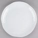 A white Tablecraft melamine tray with a pebbled rim on a gray surface.