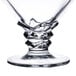 A clear glass dessert dish with a design on it.
