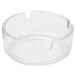 A clear glass Arcoroc ashtray with a small center hole.