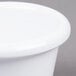 A close up of a white Carlisle smooth melamine ramekin.
