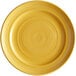 A yellow Tuxton Concentrix china plate with a spiral pattern.