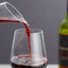 A glass of red wine being poured from a Chef & Sommelier Explore Decanter.