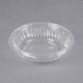 a clear plastic bowl on a gray surface