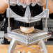 A person using a Nemco 1" square blade to chop mushrooms.